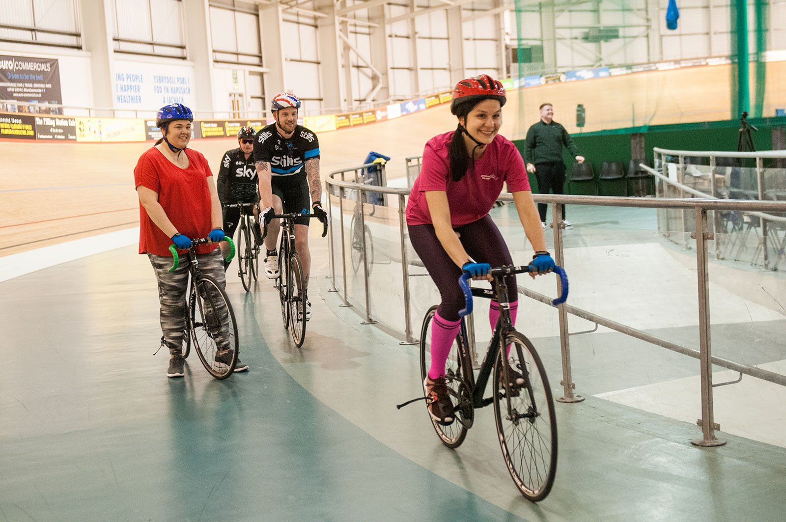 Lady in pink riding a track bike