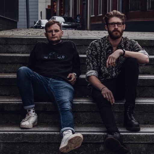 Two male musicians sitting on steps