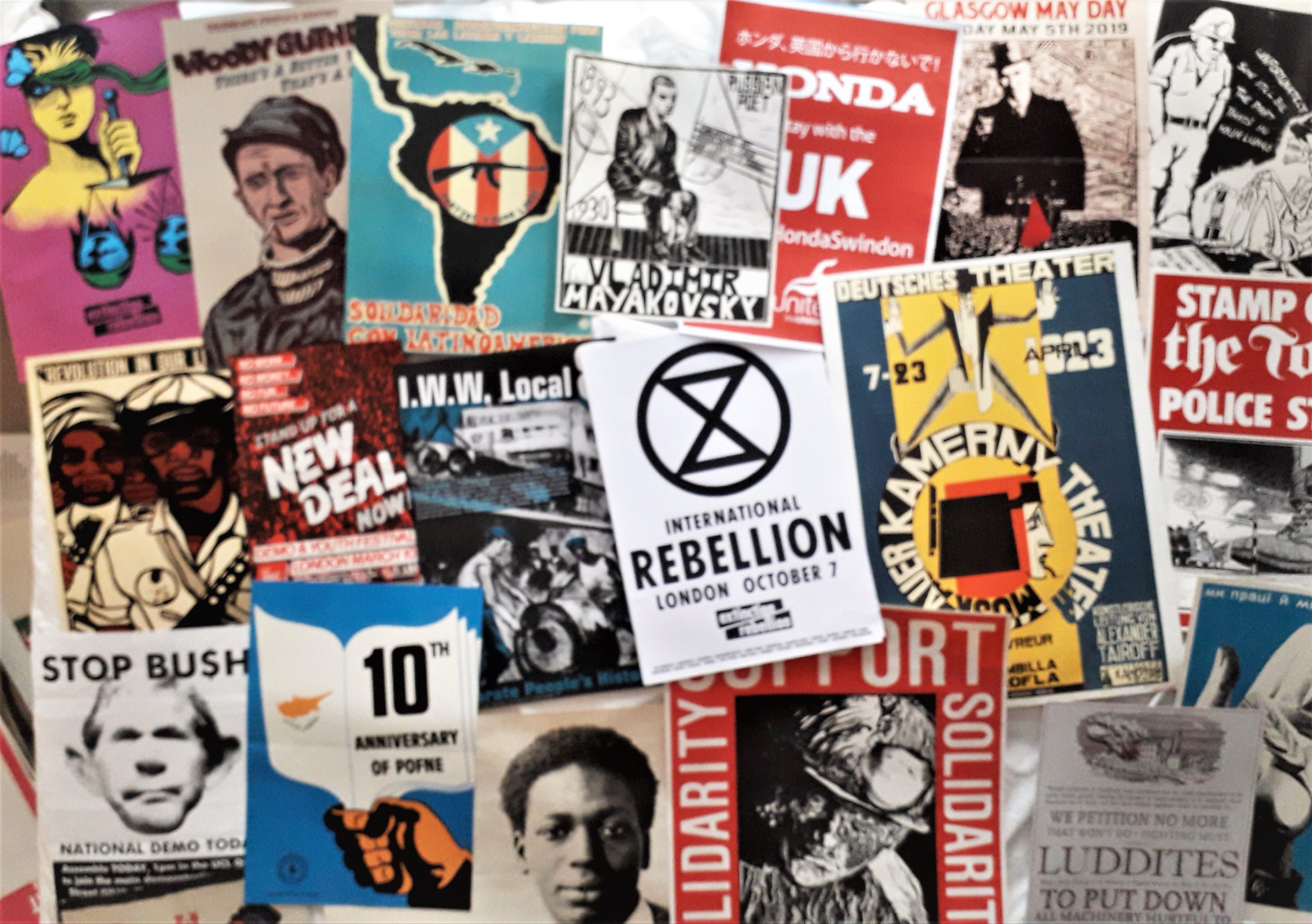 Selection of protest posters laid out overlapping one another