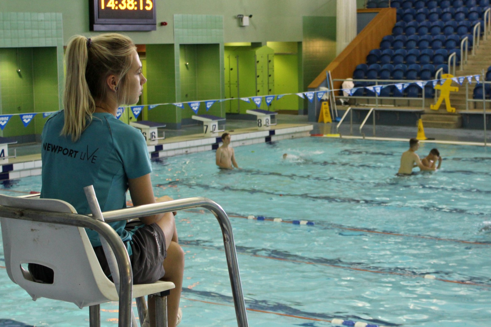 Lifeguard sitting monitoring swimming pool Lifeguard sitting monitoring swimming pool
