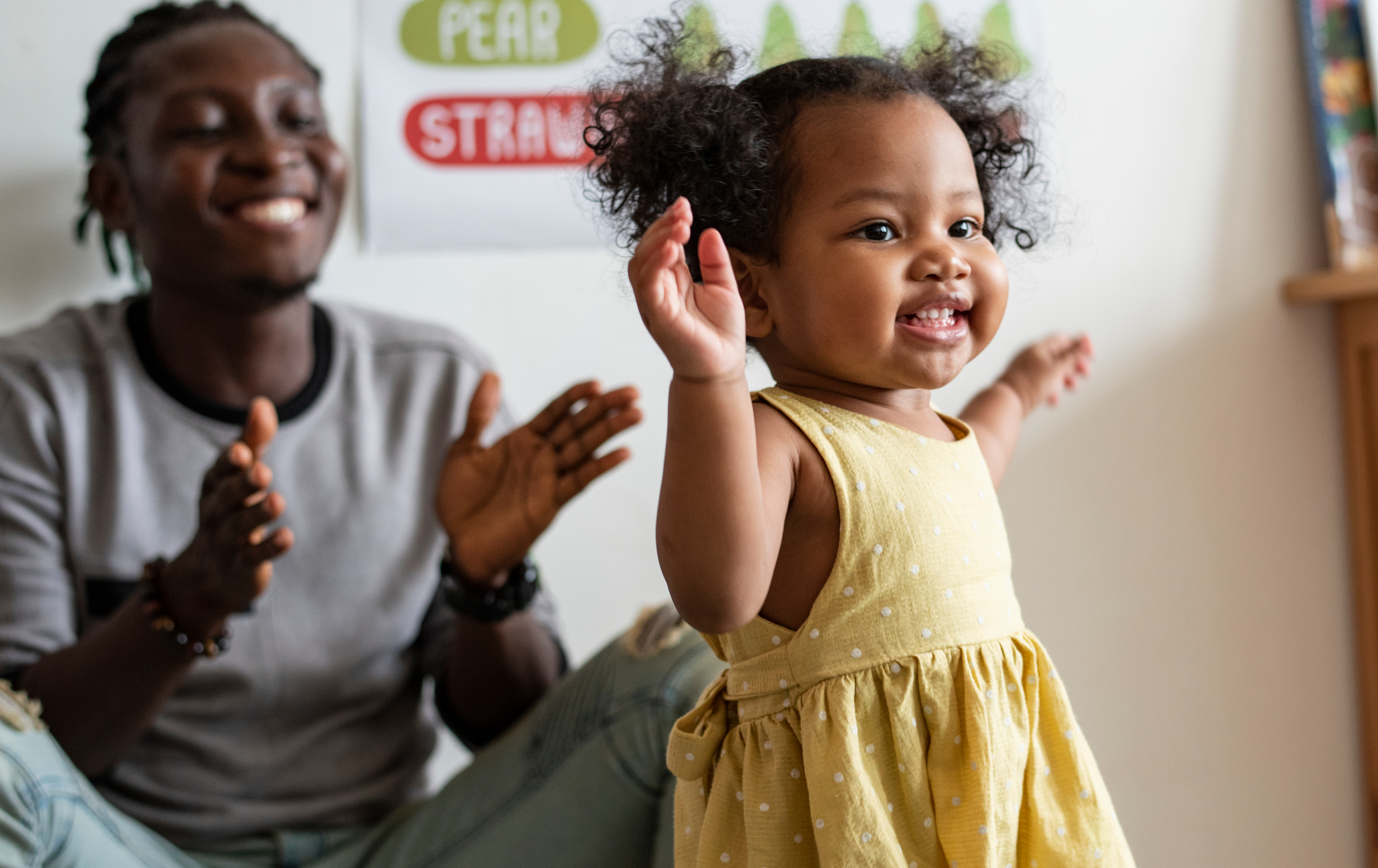 Father clapping with young child