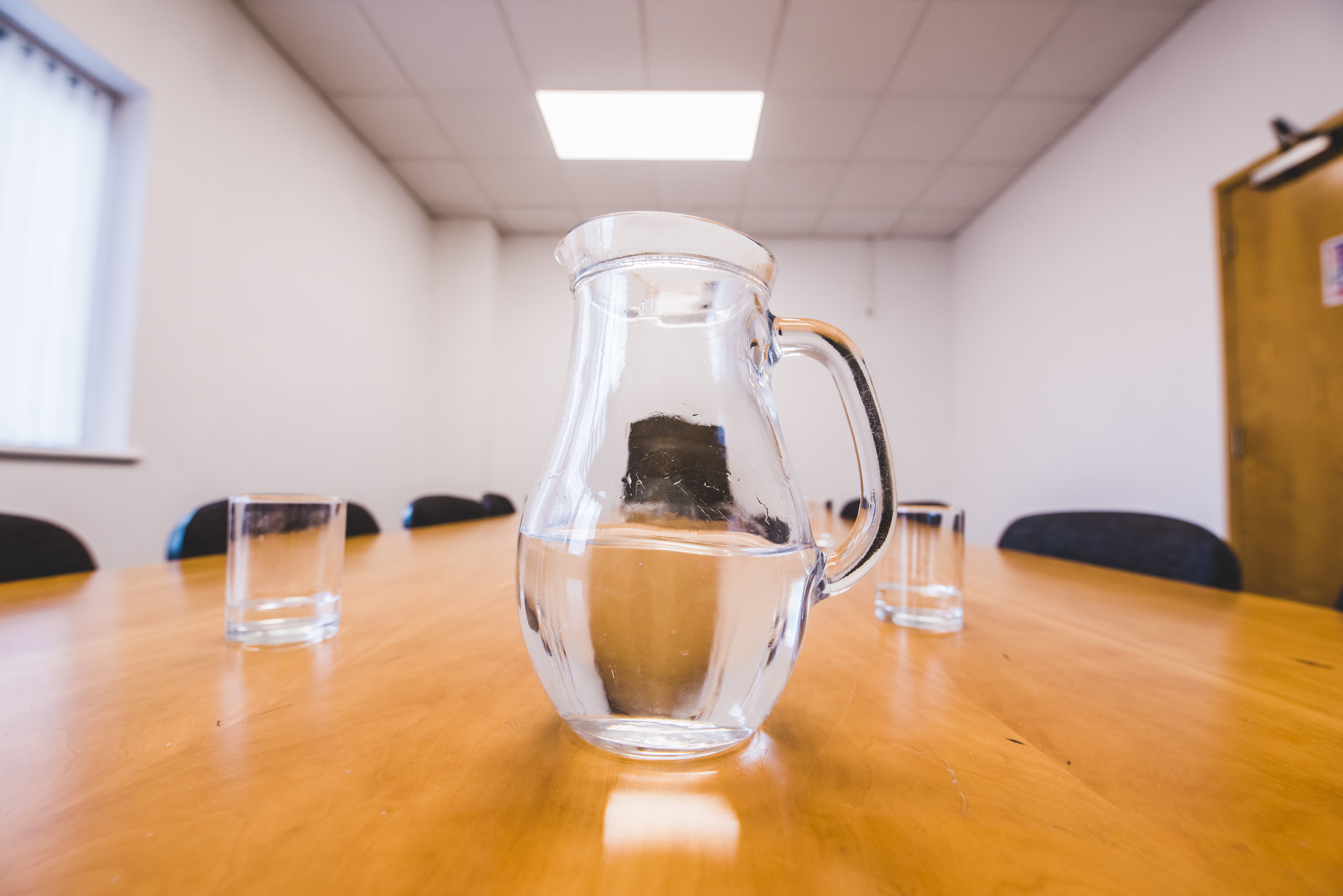 Image of conference room shot through water jug