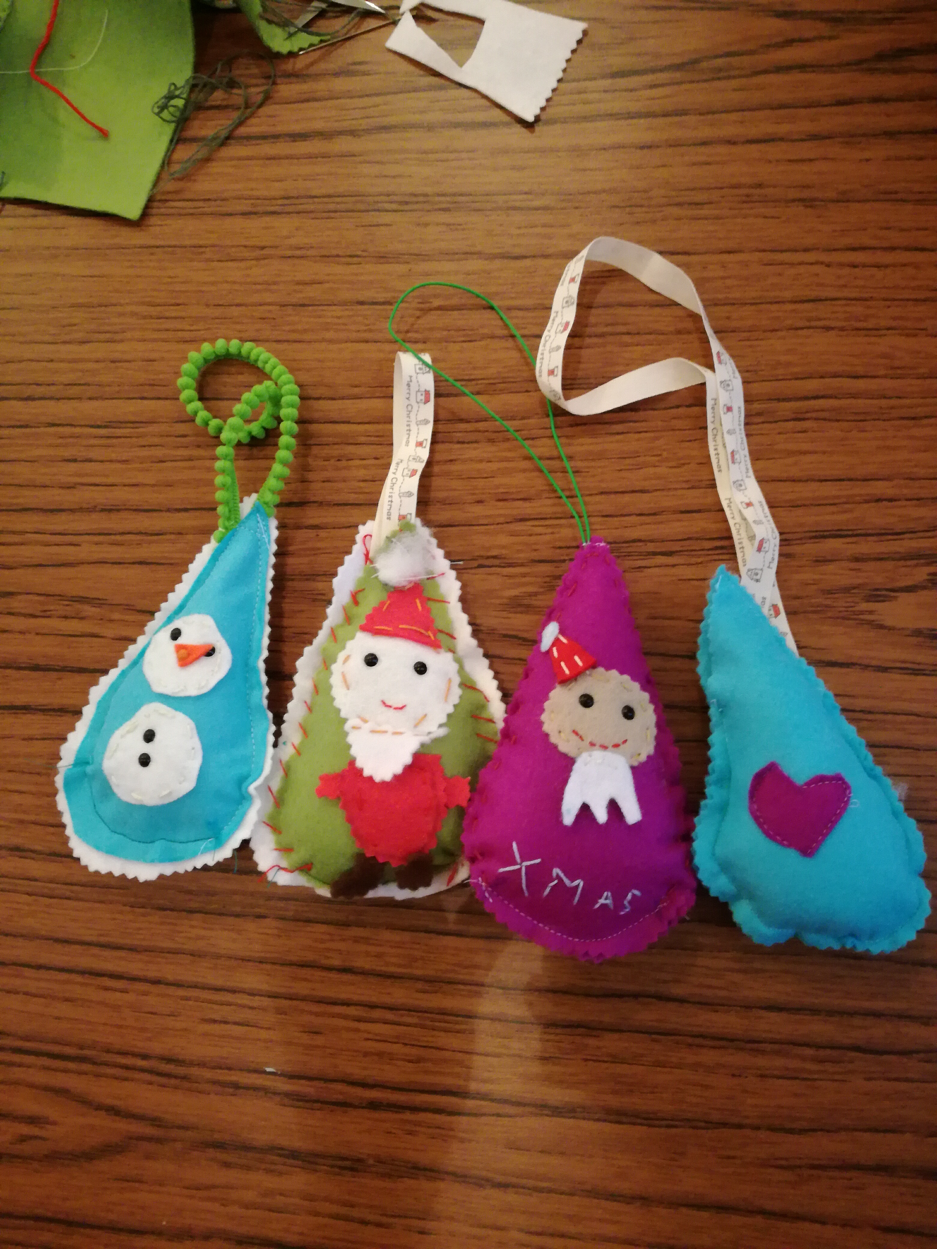 Felt Christmas tree decorations containing festive characters