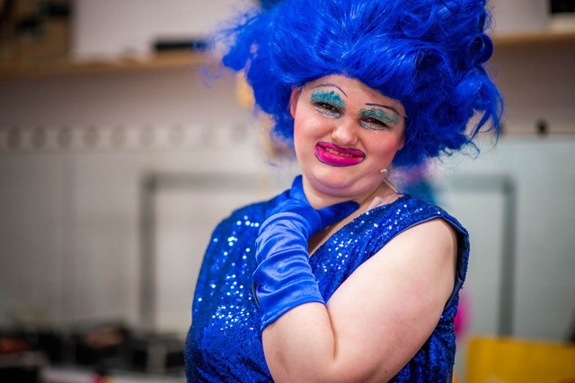 Drag Queen dressed in blue outfit and blue wig
