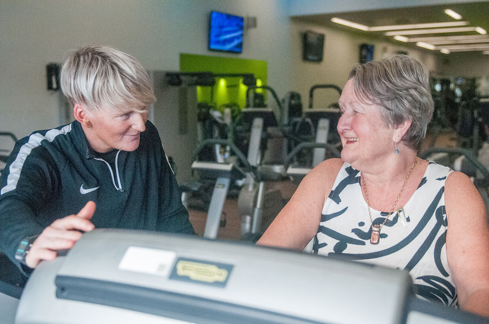 health professional chatting to a woman about fitness