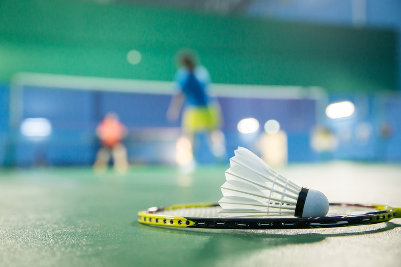 shuttlecock on a badminton racket on the ground.jpg