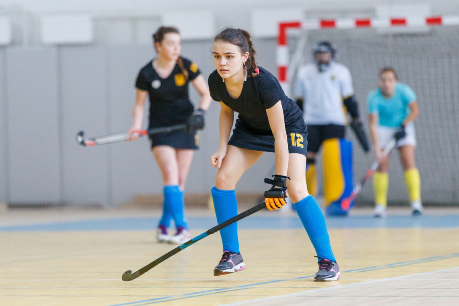 female hockey player on indoor court.jpg