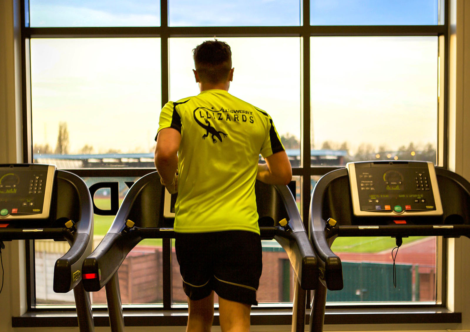 back view of a man running on a treadmill