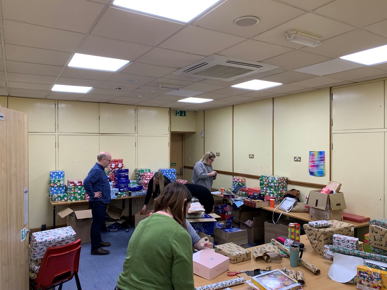 Christmas Cwtch Appeal Volunteers wrapping donations for Christmas Cwtch Appeal