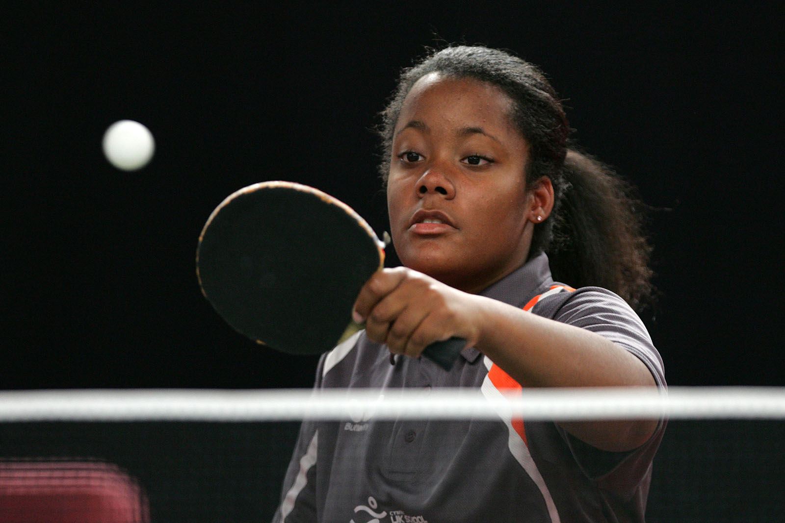 teenage girl playing table tennis