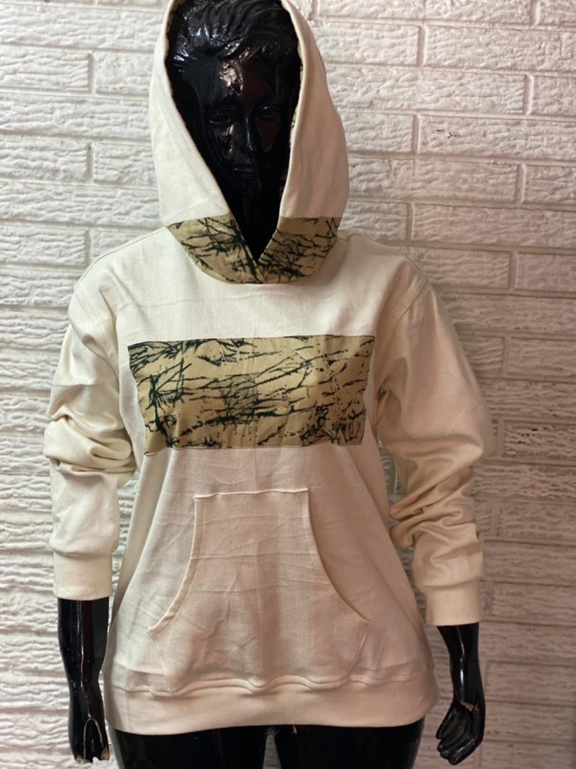 Cream hoody with patterned panel on a black mannequin.JPG