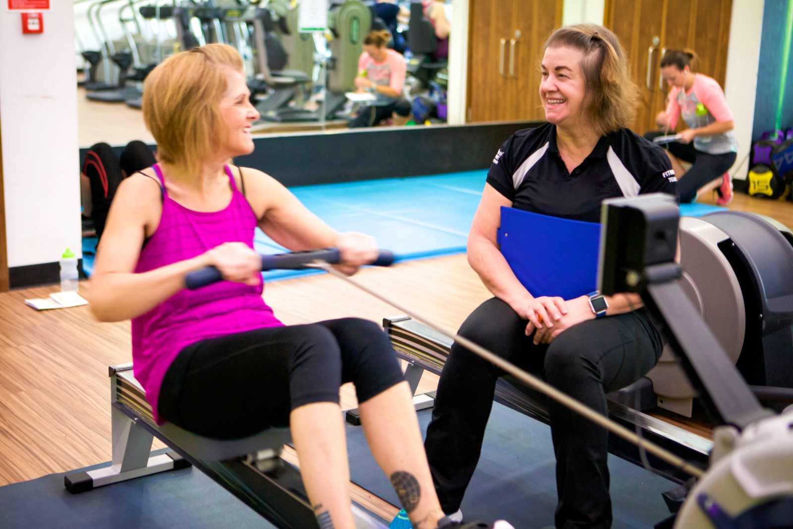 instructor supporting person on rowing machine.jpg