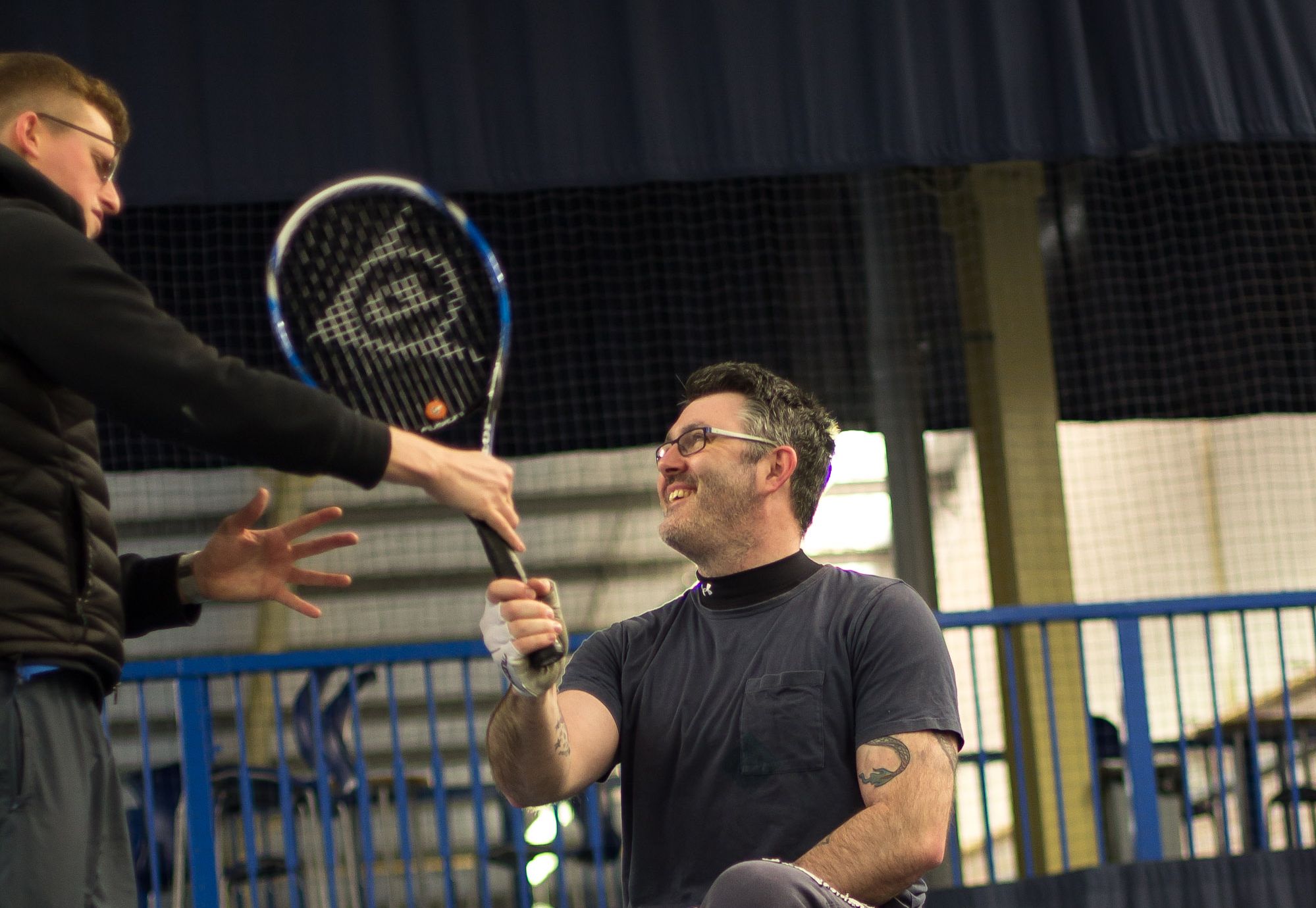 Man coaching another man in a black tshirt Man coaching another man in a black tshirt